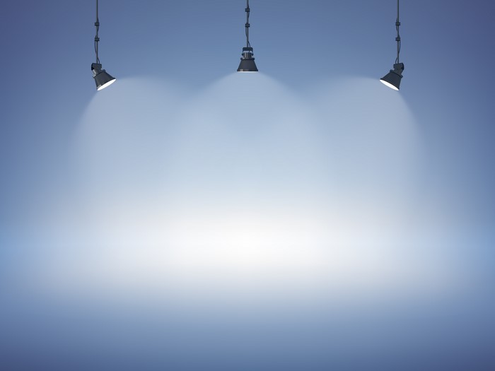 Spotlights on a blue studio wall