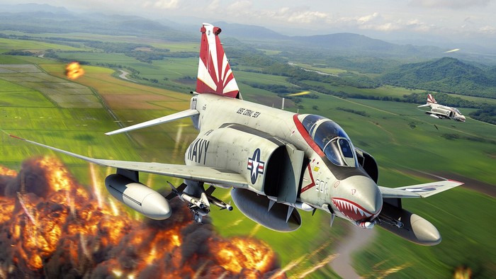 McDonnell Douglas F-4 Phantom II aircraft in flight over explosion