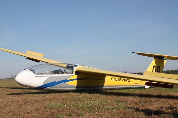 Yellow Civil Air Patrol glider on grass