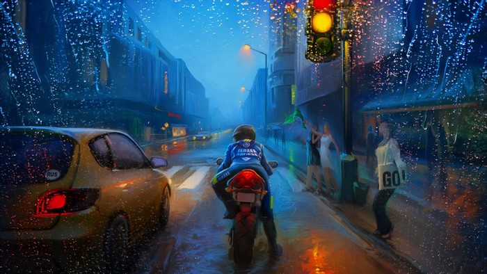 Motorcyclist in the rain at a city intersection