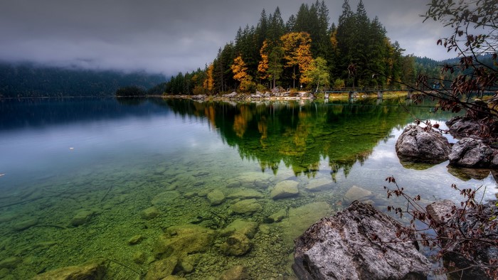 Lake Eibsee with colorful trees and mountains in Bavaria, Germany