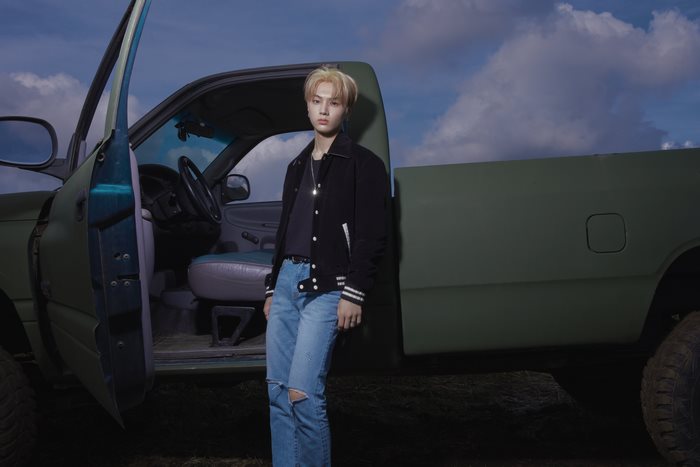 Jay ENHYPEN standing by a truck