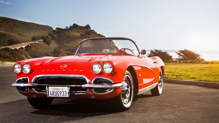 Red Chevrolet Corvette C1 Convertible on Coastal Road