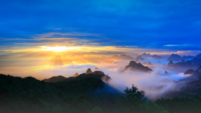 Sunrise over misty mountains in Guilin, China