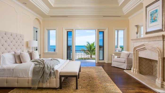 Luxury bedroom with ocean view and fireplace