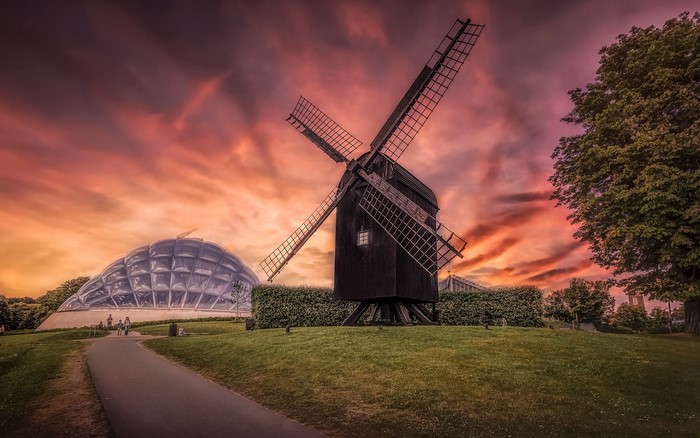 Windmill and glass dome building at sunset