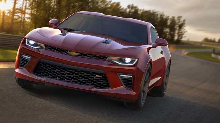 Red Chevrolet Camaro driving on a race track