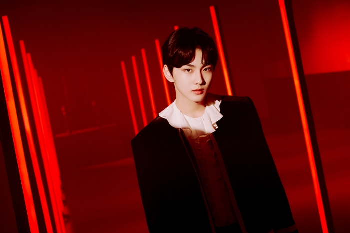 Jungwon of ENHYPEN in red lighting