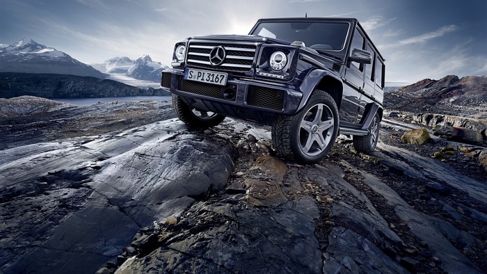 Mercedes-Benz G-Class driving on rocky terrain with mountains