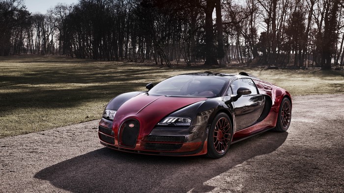 Bugatti Veyron parked on a gravel road with trees