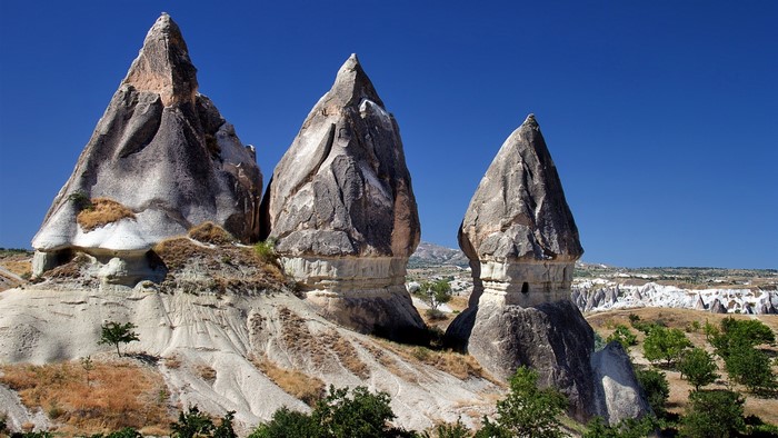 Fairy Chimneys in Cappadocia, Turkey under a clear blue sky