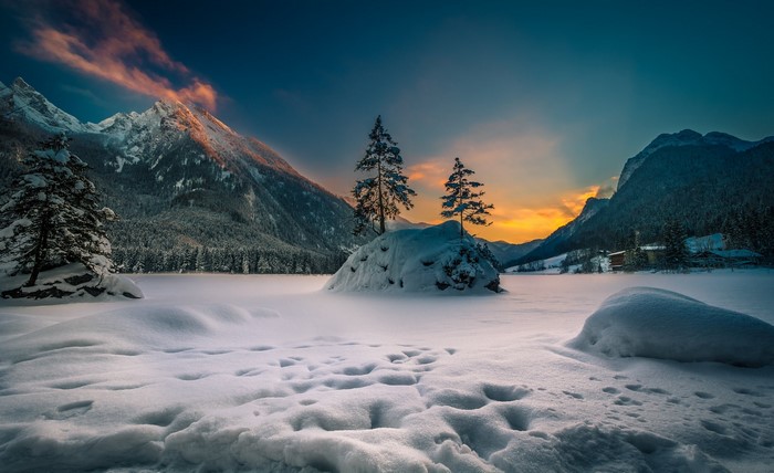 Snowy mountain landscape at sunset