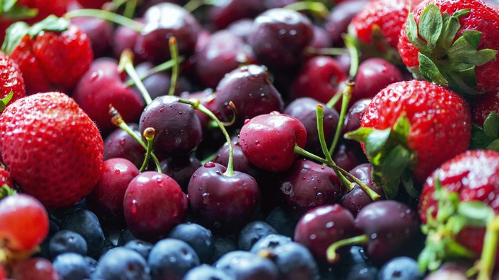 Close-up of fresh strawberries, cherries, and blueberries