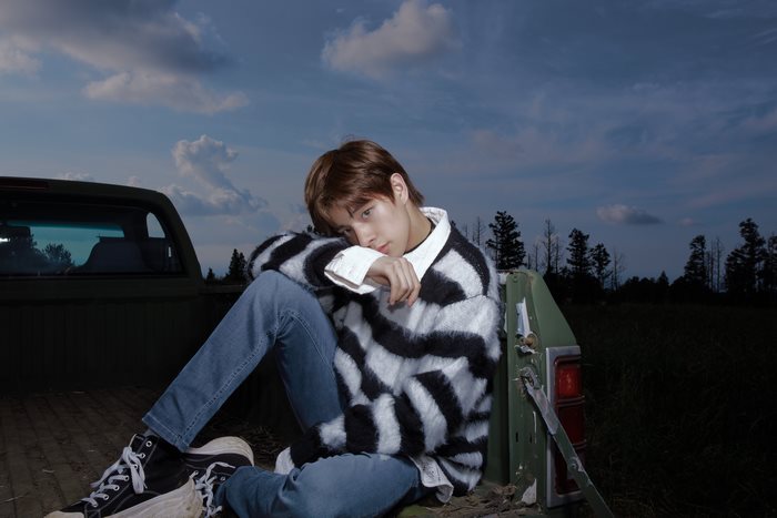Jake ENHYPEN sitting in the back of a truck