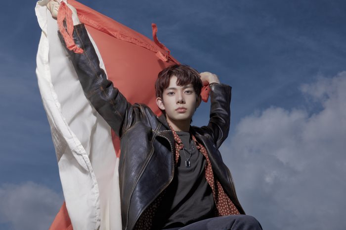 Heeseung of ENHYPEN holding a flag