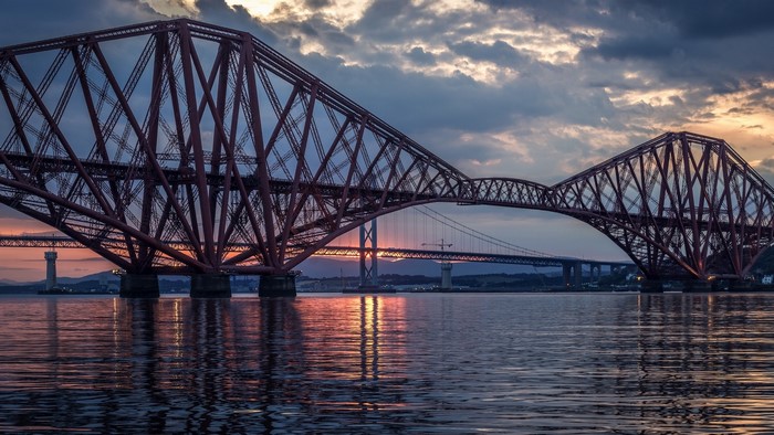 Forth Bridge at sunset with reflections