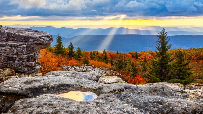 Mountain landscape with sun rays and fall foliage