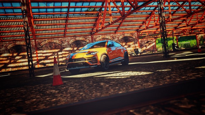 Orange Lamborghini Urus in a warehouse