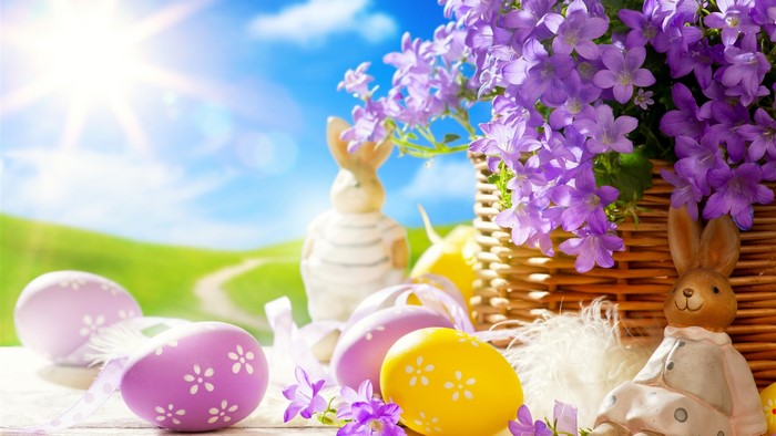 Easter eggs and flowers in a sunny field