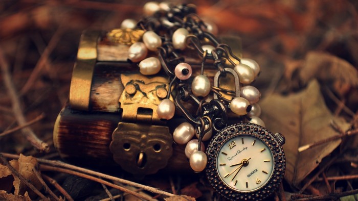 Antique wooden chest with pearl bracelet and watch
