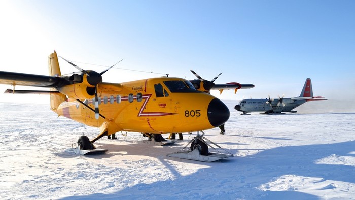 Yellow and gray aircraft on snowy terrain