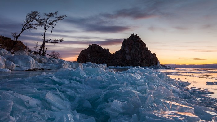 Frozen Lake Baikal with rock formations at sunset
