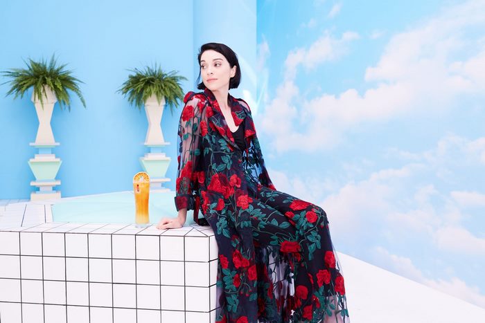 St. Vincent in a floral robe with a drink