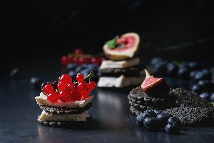 Cheese and fruit appetizers with berries and figs