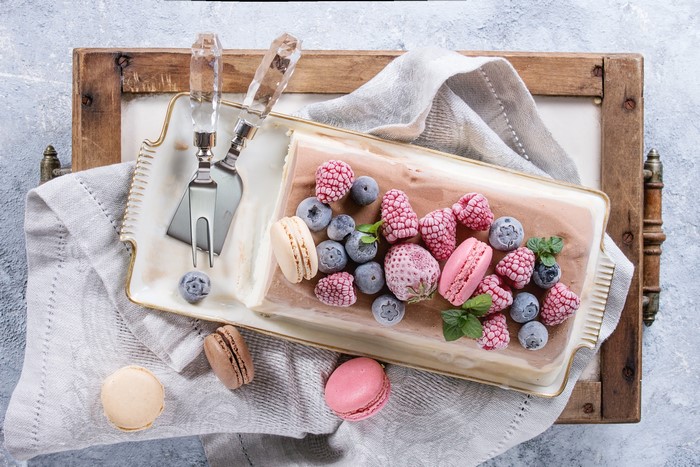 Chocolate ice cream log with berries and macarons