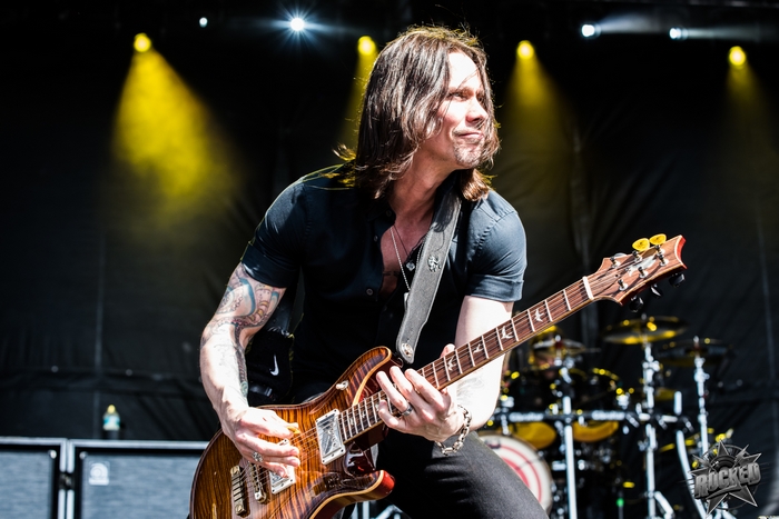 Myles Kennedy playing guitar on stage