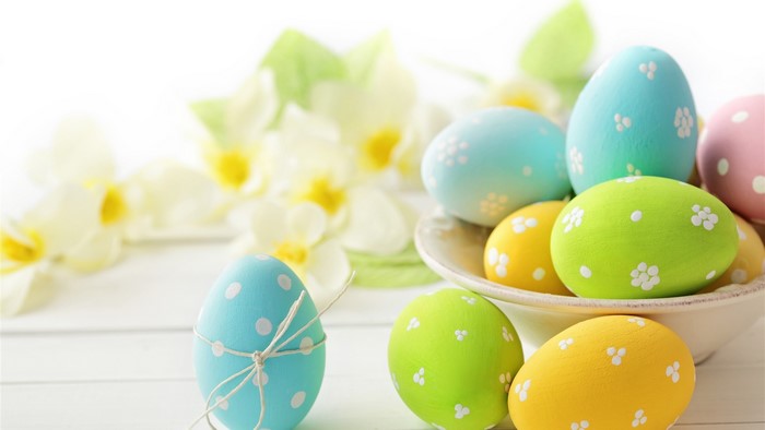 Easter eggs with flowers on a white table