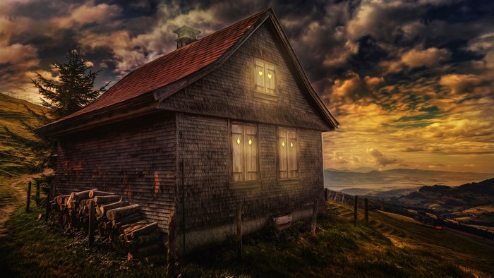 Wooden house on a hill with a dramatic sky