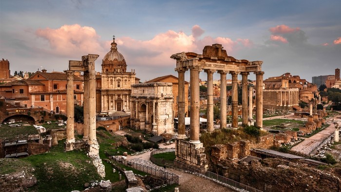 Ancient Roman ruins with columns and a dome building