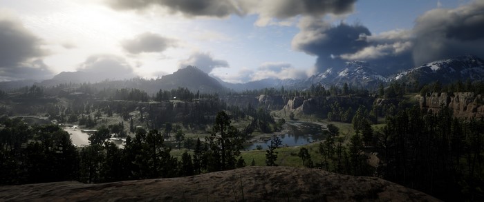 Red Dead Redemption 2 landscape with mountains and river