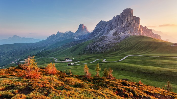 Winding road through green mountains in the Dolomites, Italy