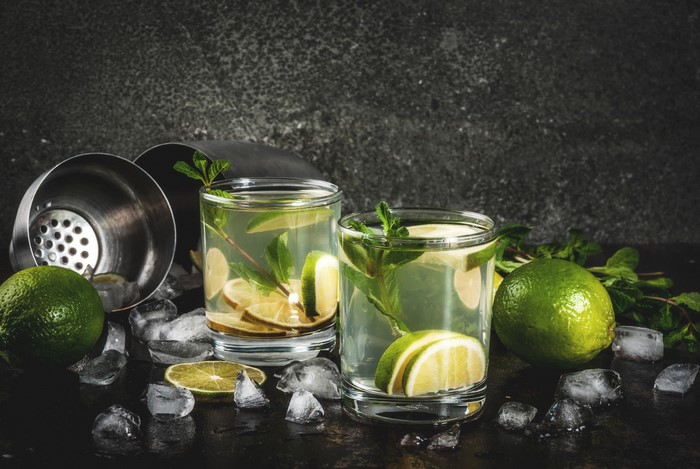 Two glasses of mojito with limes and mint
