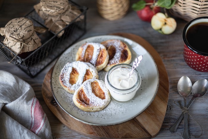 Sweet apple pancakes with cream and coffee