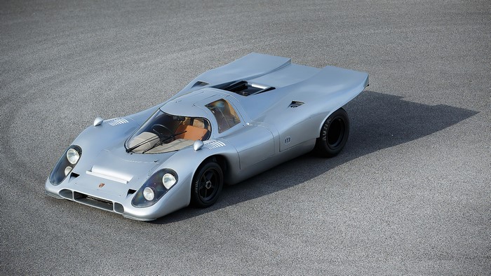 Silver Porsche 917 Longtail race car on asphalt