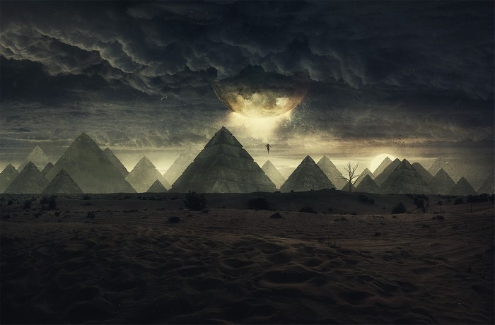 Surreal desert landscape with pyramids and a moon