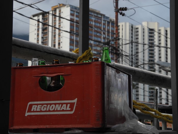 Red crate with bottles and buildings