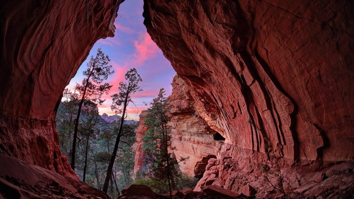 Cave entrance overlooking sunset in Red Rock State Park, Arizona