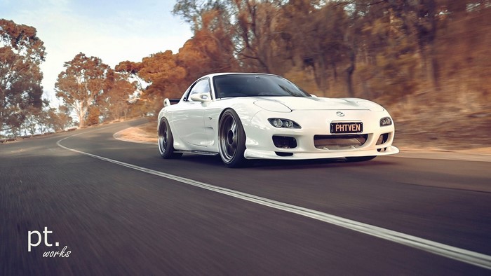 White Mazda RX-7 FD on a winding road