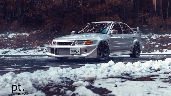 Silver Mitsubishi Lancer Evolution parked on a snowy road
