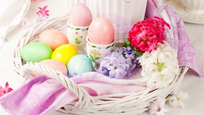 Easter basket with painted eggs and hyacinth flowers