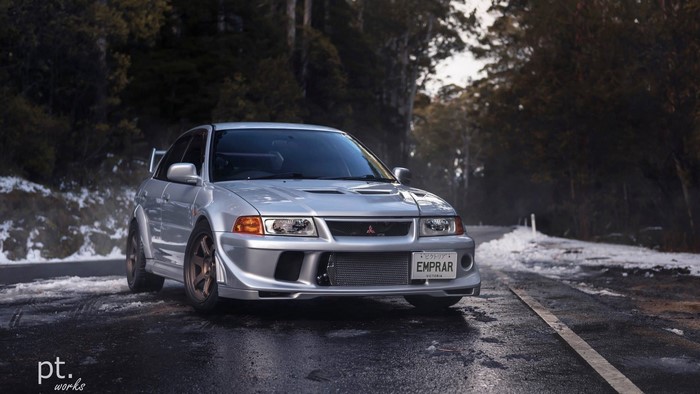 Silver Mitsubishi Lancer Evolution on a Snowy Road