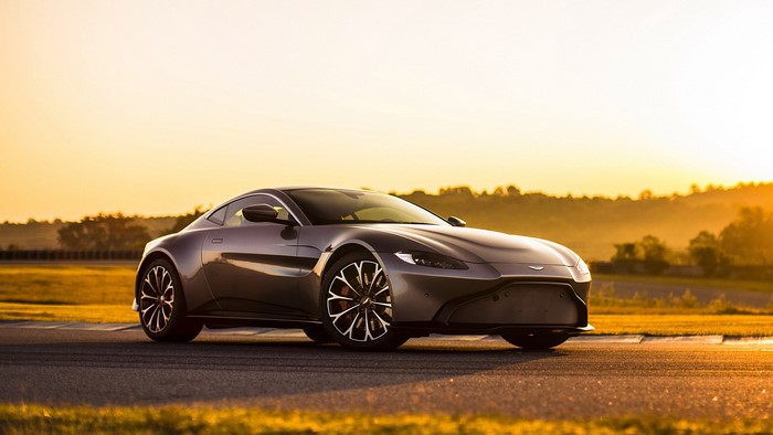 Aston Martin Vantage on a road at sunset