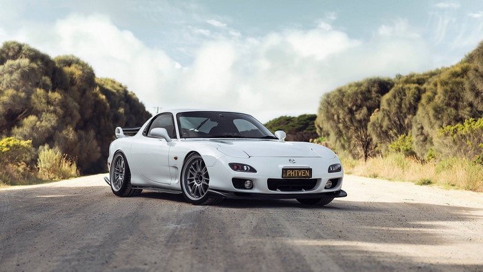 White Mazda RX-7 FD sports car on a dirt road