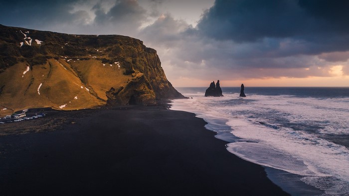 Black sand beach with sea stacks and cliffs in Iceland