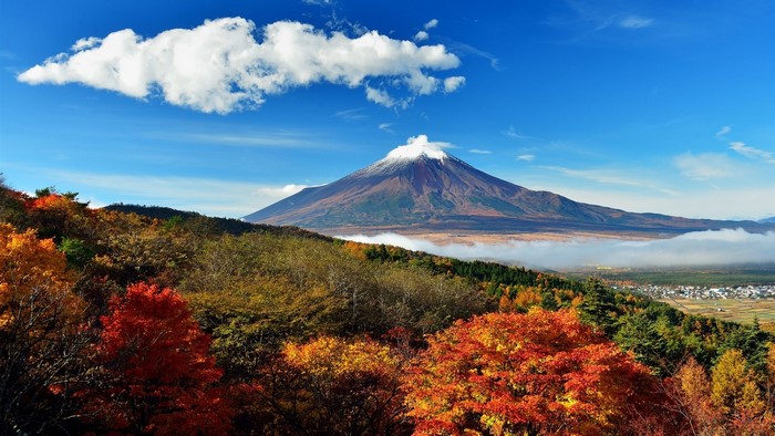 Mount Fuji in autumn with colorful trees and clouds