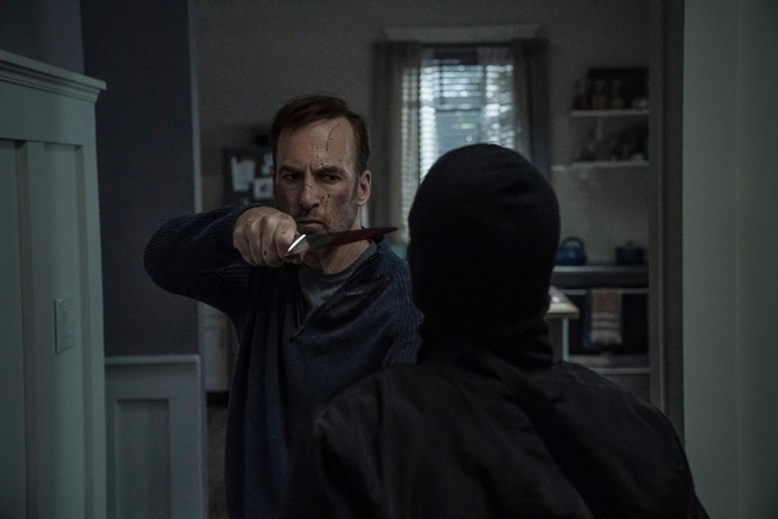 Bob Odenkirk holds a bloody knife